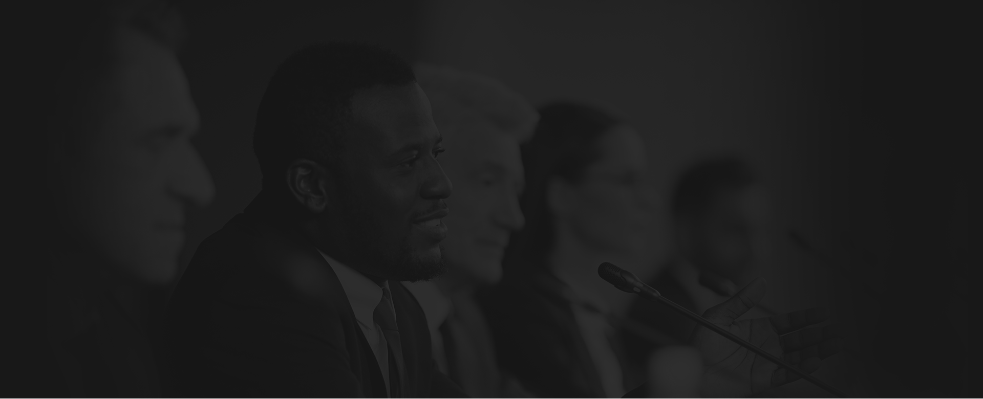 man smiling and looking at something offscreen to the right