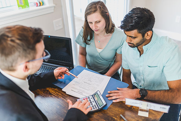 couple looking at documents with a loan officer